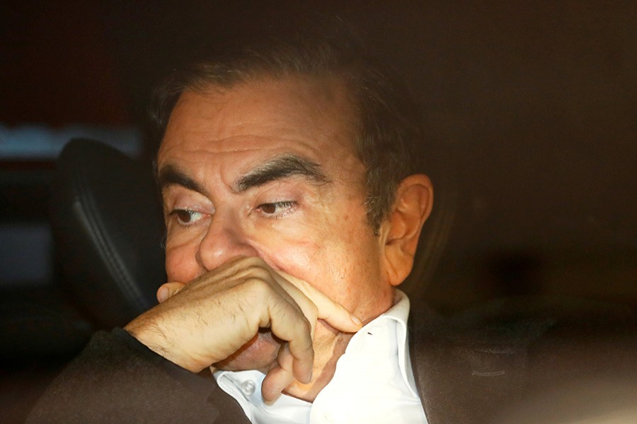 Former Nissan Motor Chairman Carlos Ghosn sits inside a car as he leaves his lawyer's office after being released on bail from Tokyo Detention House, in Tokyo, Japan on March 6, 2019 — Reuters photo