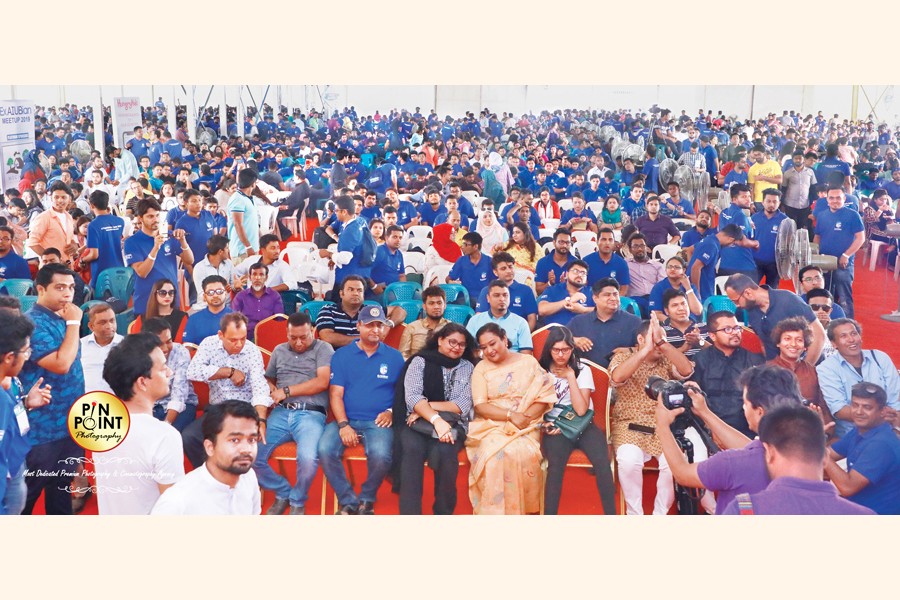 Former AIUB students and their family members enjoying performance at the get-together of the university