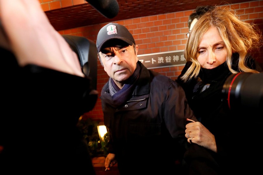 FILE PHOTO: Former Nissan Motor Chairman Carlos Ghosn accompanied by his wife Carole Ghosn, arrives at his place of residence in Tokyo, Japan, March 8, 2019 - REUTERS/Issei Kato/File Photo