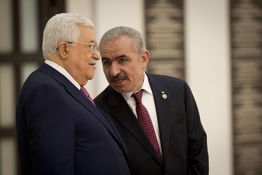 Palestinian Prime Minister Mohammad Ishtayeh, right, talks with Palestinian President Mahmoud Abbas during a swearing in of the new government in the West Bank city of Ramallah on Saturday. -AP Photo