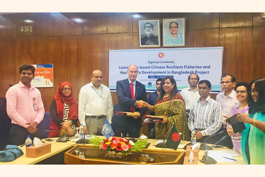 Sultana Afroze, additional secretary of the Economic Relations Division (ERD) under the Ministry of Finance, and Robert Doglus Simpson, FAO Representative in Bangladesh, exchanging documents after signing the agreements on behalf of their respective sides at the ERD conference room in the city on Tuesday