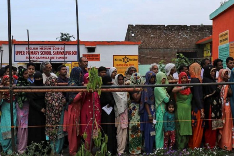 Voters line up to cast their votes outside a polling station during the second phase of general election in Amroha, in Uttar Pradesh, April 18, 2019. Reuters