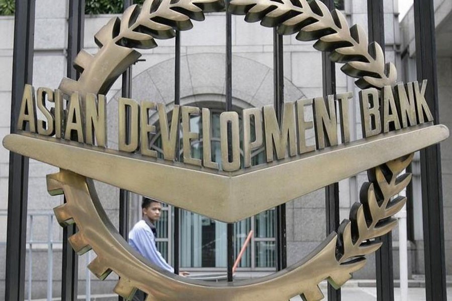 A worker walks past inside the Asian Development Bank (ADB) headquarters in Manila, Philippines, June 17, 2009. Reuters/Files