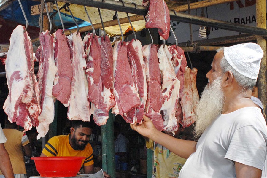 Raw beef meat seen hanging on hooks for display at a butcher shop in Demra's Sarulia bazar, Dhaka — Focus Bangla/Files