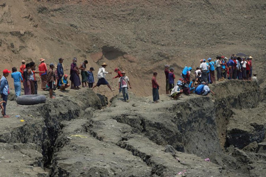 Local people look on in a jade mine where the mud dam collapsed in Hpakant, Kachin state, Myanmar on April 23, 2019 — Reuters photo