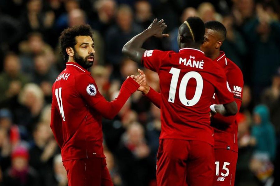 Premier League - Liverpool v Huddersfield Town - Anfield, Liverpool, Britain - April 26, 2019 Liverpool's Mohamed Salah celebrates scoring their third goal with team mates, Action Images via Reuters/Jason Cairnduff