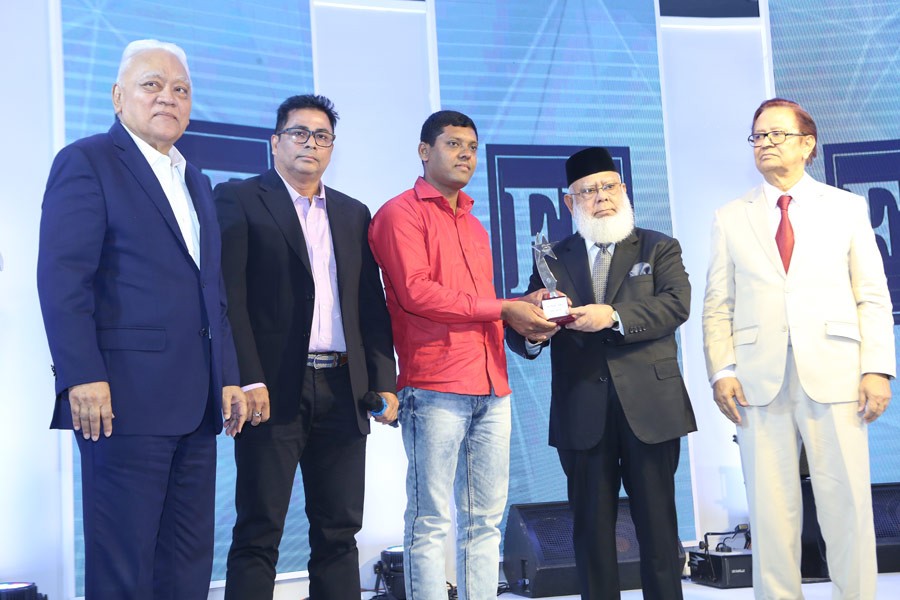 International Publications Limited (IPL) Chairman Mahbubur Rahman handing over an award to Mr Rubel Dewan (third from left) for his contribution to the dairy farm sector, at the FE anniversary celebration in the city on Tuesday. IPL Managing Director Syed Manzur Elahi (extreme left) and FE Editor Shah Hussain Imam (extreme right) were also present. Award recipient Mr Monjurul Islam, Vice President and head of production at Continental Garments, is also seen.  –FE Photo