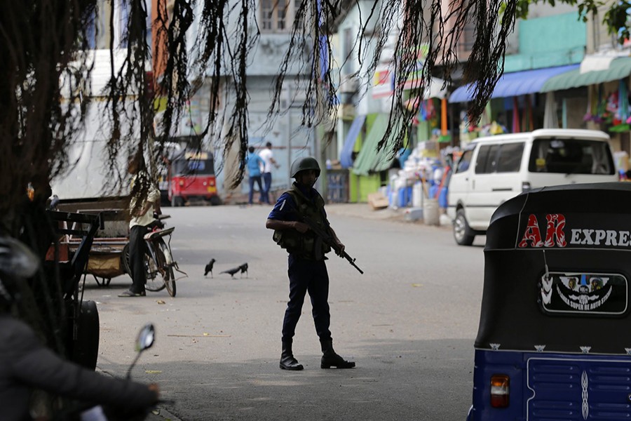 A Sri Lankan naval soldier stands guard at a road leading to a closed market on May Day in Colombo, Sri Lanka on May 1, 2019 — AP photo