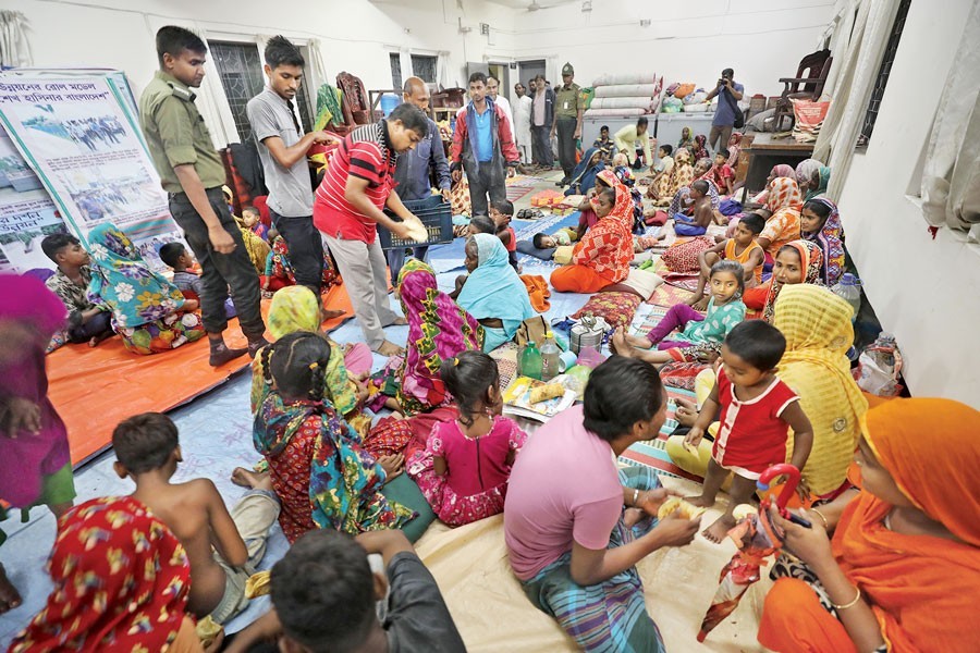 People seen taking shelter in the Mongla Pourashava Bhaban to escape wrath of the Cyclone Fani Friday evening — FE photo