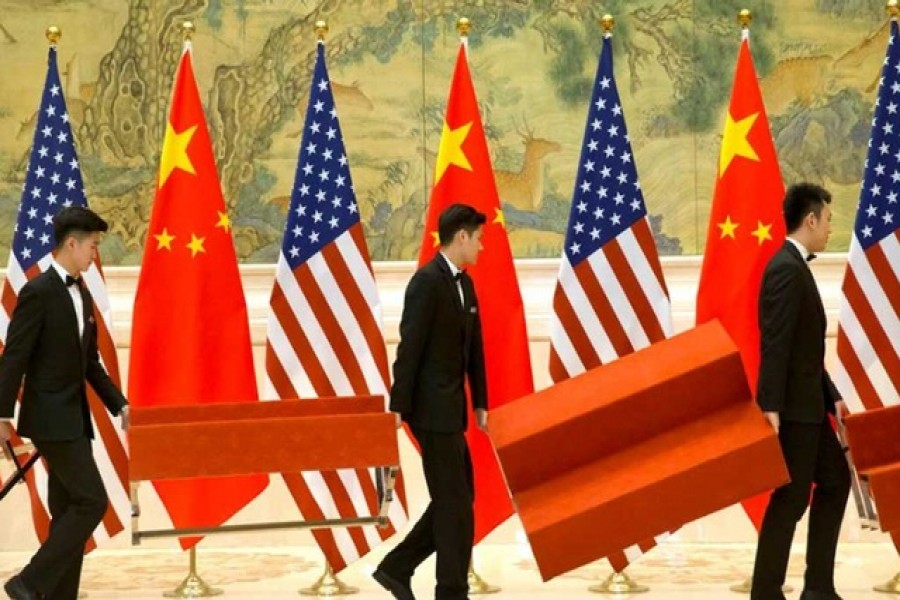 Aides set up platforms before a group photo with members of US and Chinese trade negotiation delegations at the Diaoyutai State Guesthouse in Beijing, China, February 15, 2019. Mark Schiefelbein/Pool via Reuters