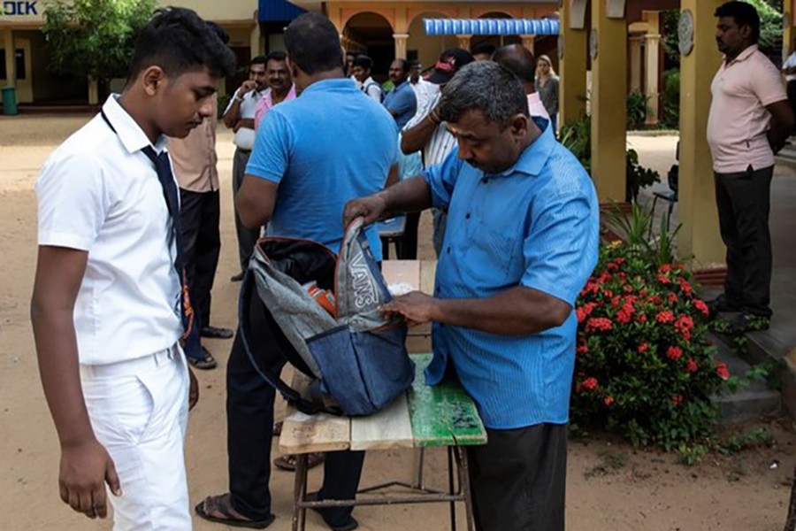 A student's bag is searched by a parent as he arrives at his school which opened days after a string of suicide bomb attacks across the island on Easter Sunday, in Batticaloa, Sri Lanka on May 6, 2019 — Reuters photo