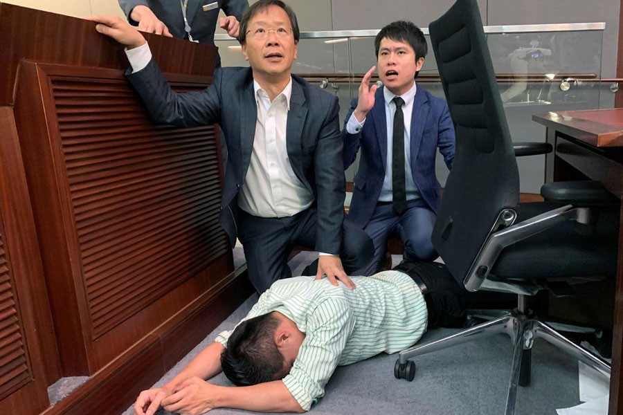 Pro-democracy lawmaker Gary Fan lies down after clashs with pro-Beijing lawmakers during a meeting for control of a meeting room to consider the controversial extradition bill, in Hong Kong, China May 11, 2019 - REUTERS/James Pomfret