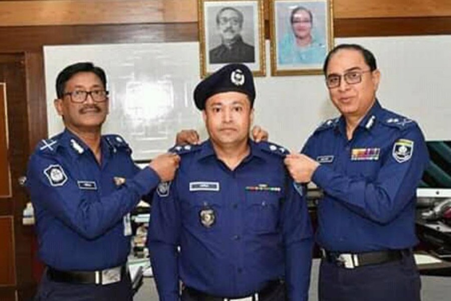 Kazi Moniruzzaman seen receiving his badge from top officials as the new superintendent of Feni Police