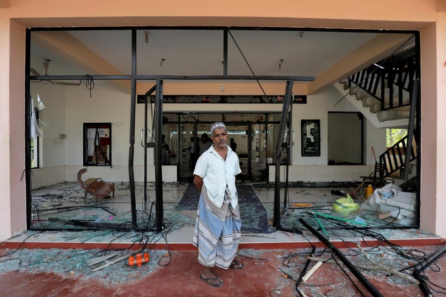 A Muslim man stands in front of the Abbraar Masjid mosque after a mob attack in Kiniyama, Sri Lanka, May 13, 2019. Reuters