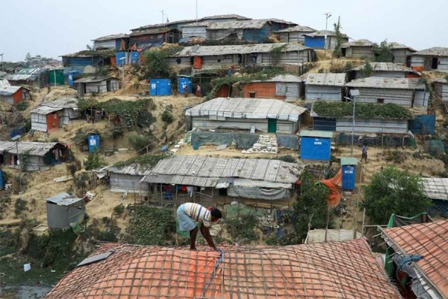 A Rohingya refugee repairs the roof of his shelter at the Balukhali refugee camp in Cox's Bazar, Bangladesh, March 5, 2019. Reuters/Files