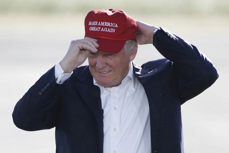 Donald Trump, then Republican presidential candidate, wears his "Make America Great Again" hat at a rally in Sacramento, California  in June 2016.                 —Photo: AP