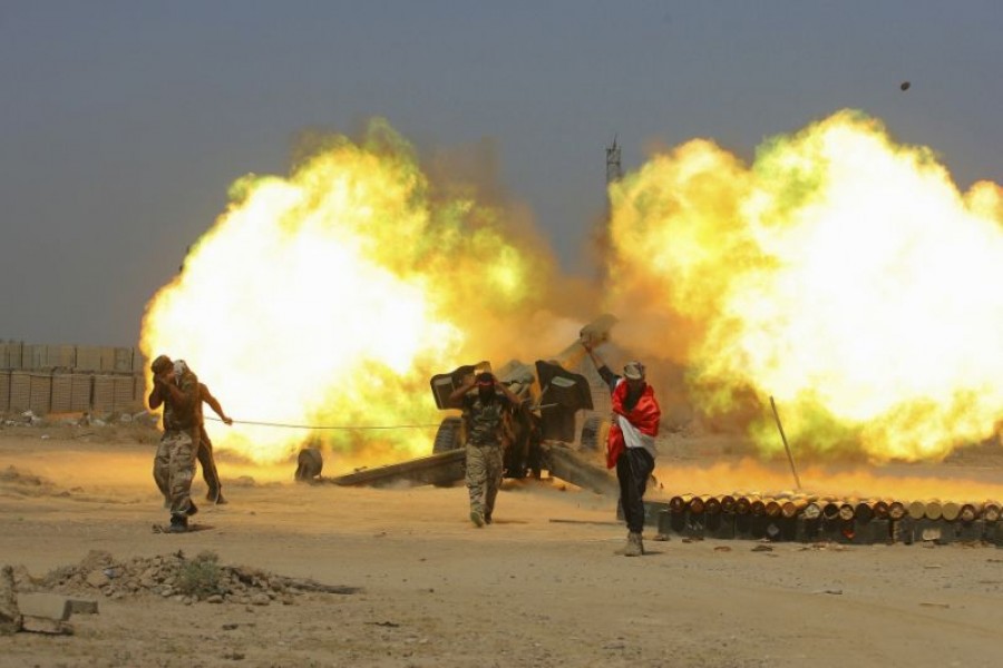 In this May 29, 2016 file photo, Iraqi security forces and allied Popular Mobilization forces fire artillery during fight against Islamic State militants in Fallujah, Iraq. When US Secretary of State Mike Pompeo sat down with Iraqi officials in Baghdad earlier this month as tensions were mounting between the US and Iran, he delivered a nuanced message: If you're not going to stand with us, stand aside. Photo: AP