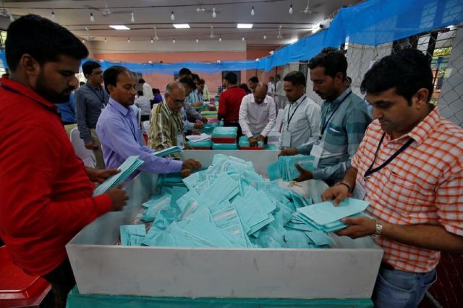 Election staff members count votes at a vote counting centre in Mumbai, India, May 23, 2019. Reuters