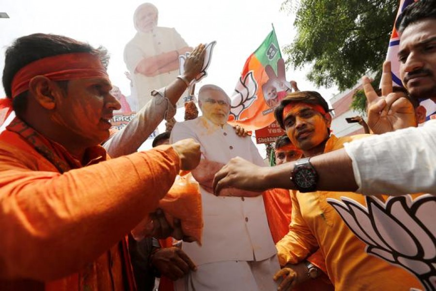 BJP supporters celebrate after learning the initial election results outside the party headquarters in New Delhi, India, May 23, 2019. Reuters