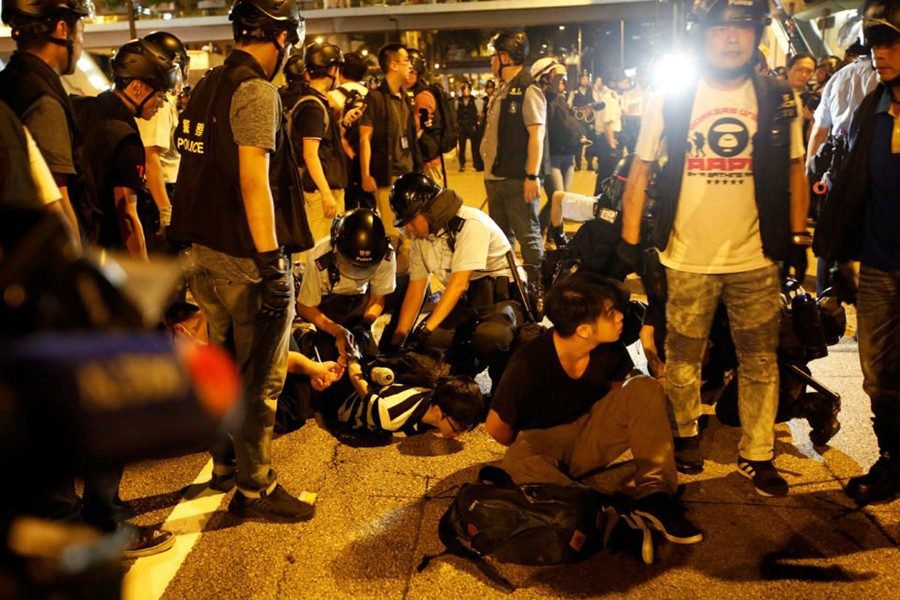 Police officers detain protesters during a protest to demand authorities scrap a proposed extradition bill with China, on Gloucester Road in Hong Kong, China on June 10, 2019 — Reuters photo