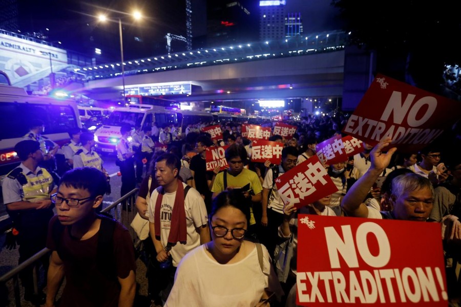 Demonstrators hold signs during a protest to demand authorities scrap a proposed extradition bill with China, in Hong Kong, China, June 9, 2019. Reuters