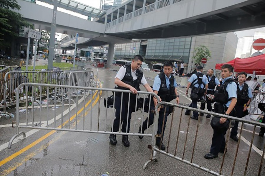 Police close a barrier surrounding the Legislative Council building after violent clashes during a protest against a proposed extradition bill with China in Hong Kong, China, on June 13, 2019 — Reuters photo