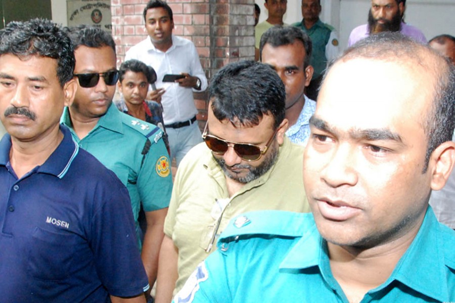 Dhaka police hand over former Sonagazi OC Moazzem Hossain (second from right) to Sonagazi Police officials on Monday morning — Focus Bangla photo