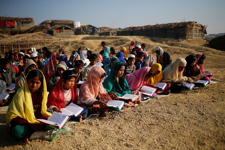 Rohingya refugee children attend an open air Arabic school at Kutupalang Unregistered Refugee Camp, where they learn to read the Quran, in Cox's Bazar, Bangladesh — Reuters/Files