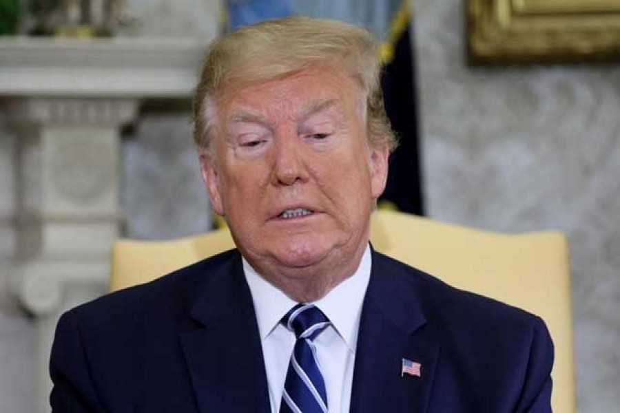 US President Donald Trump listens to questions from reporters during a meeting with Canada's Prime Minister Justin Trudeau in the Oval Office of the White House in Washington, US, June 20, 2019. Reuters