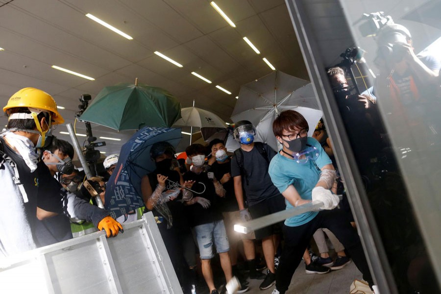 Protesters breaking into the Legislative Council building during the anniversary of Hong Kong's handover to China in Hong Kong, China on Monday	— Reuters