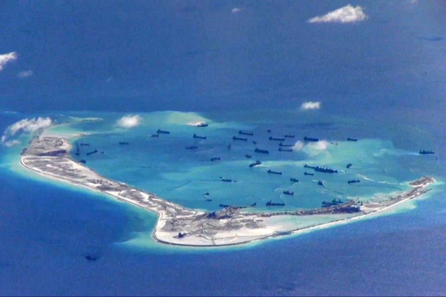 Chinese dredging vessels are purportedly seen in waters around Mischief Reef in the disputed Spratly Islands in the South China Sea, in this still image from video taken by a P-8A Poseidon surveillance aircraft of US Navy — via Reuters/Files