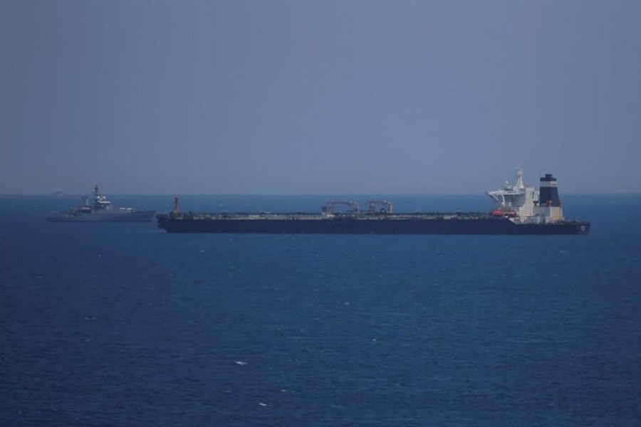 FILE PHOTO: A British Royal Navy patrol vessel guards the oil supertanker Grace 1, that's on suspicion of carrying Iranian crude oil to Syria, as it sits anchored in waters of the British overseas territory of Gibraltar, historically claimed by Spain, July 4, 2019 - REUTERS/Jon Nazca