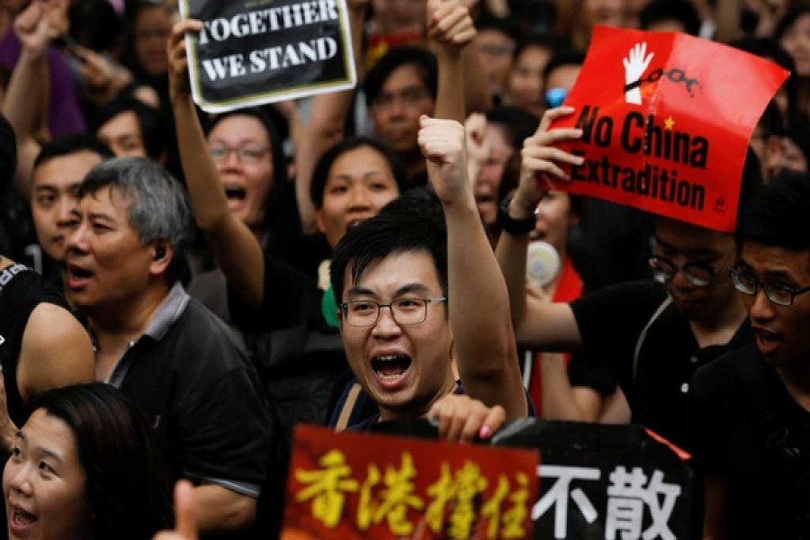 Anti-extradition bill protesters shout slogans as they march to West Kowloon Express Rail Link Station in Hong Kong, China July 7, 2019. Reuters