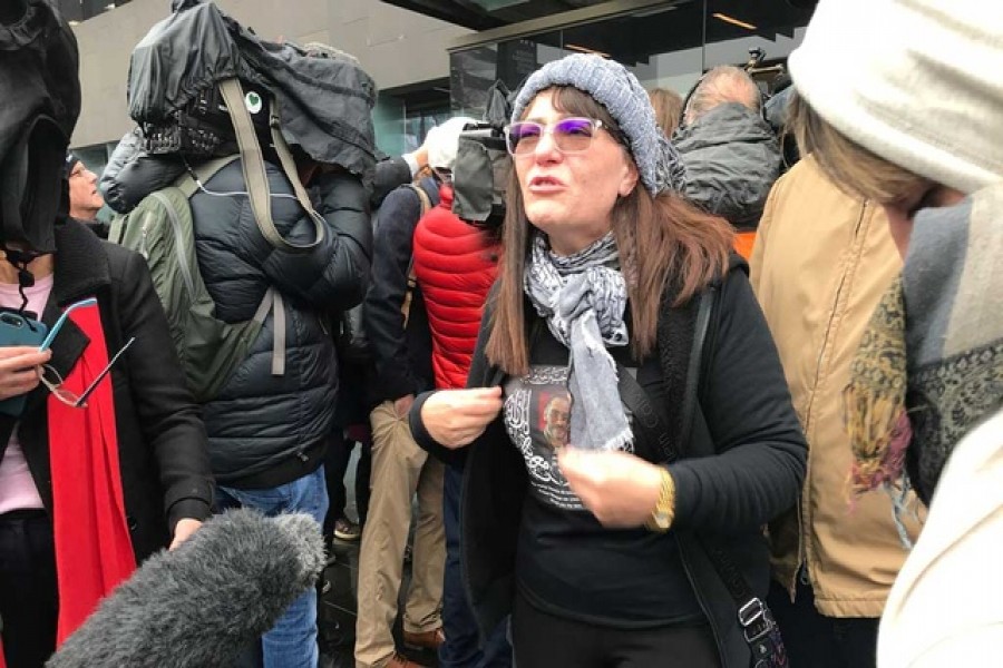 Janna Ezat, wearing a T-shirt in memory of her son who was killed at Al Noor mosque on March 15, reacts outside the Christchurch High Court after accused gunman Brenton Tarrant pleaded not guilty to all charges, in New Zealand on Jun 14. Reuters