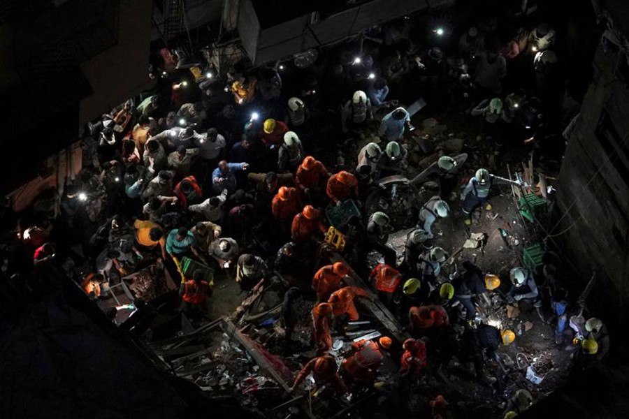 Rescue workers search for survivors at the site of a collapsed building in Mumbai, India, on July 16, 2019 — Reuters photo