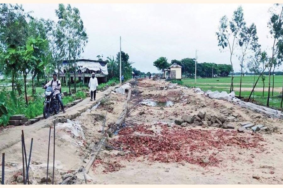 A road severely damaged by flood in Sunamganj district	— FE Photo