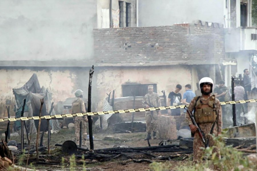 Pakistan soldiers and officers survey the site after a military aircraft on a training flight crashed in a built-up area in the garrison city of Rawalpindi, Pakistan on July 30, 2019 — Reuters photo