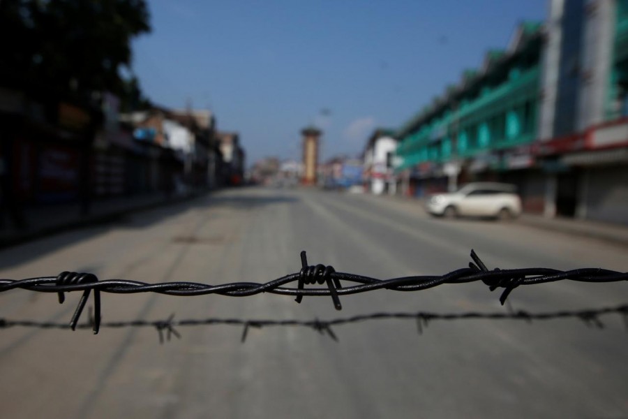 Barbed wire is seen laid on a deserted road during restrictions in Srinagar, August 5, 2019 - REUTERS/Danish Ismail