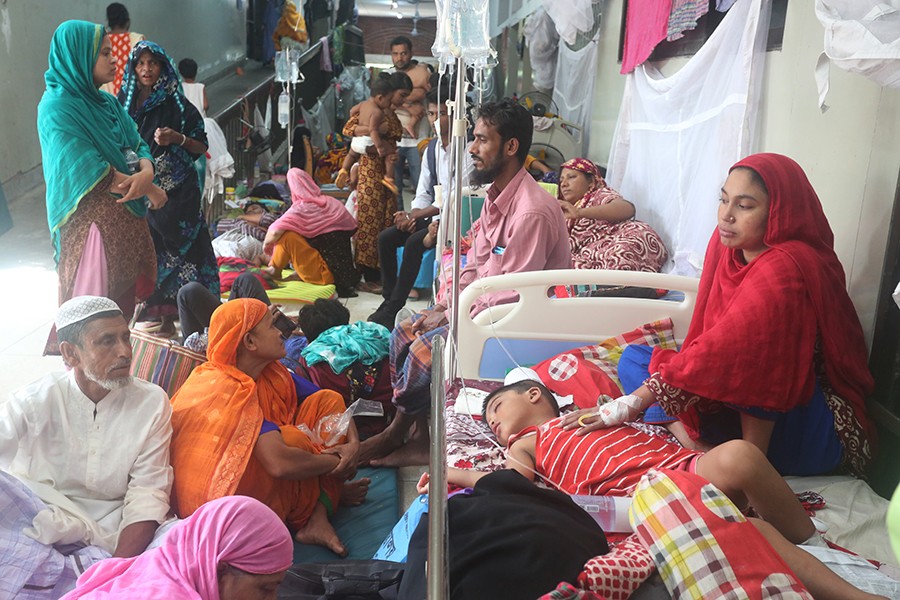 Dengue patients undergoing treatment on a floor at Shaheed Suhrawardy Medical College and Hospital in the capital on Tuesday, following a heavy rush of such patients — FE Photo by KAZ Sumon