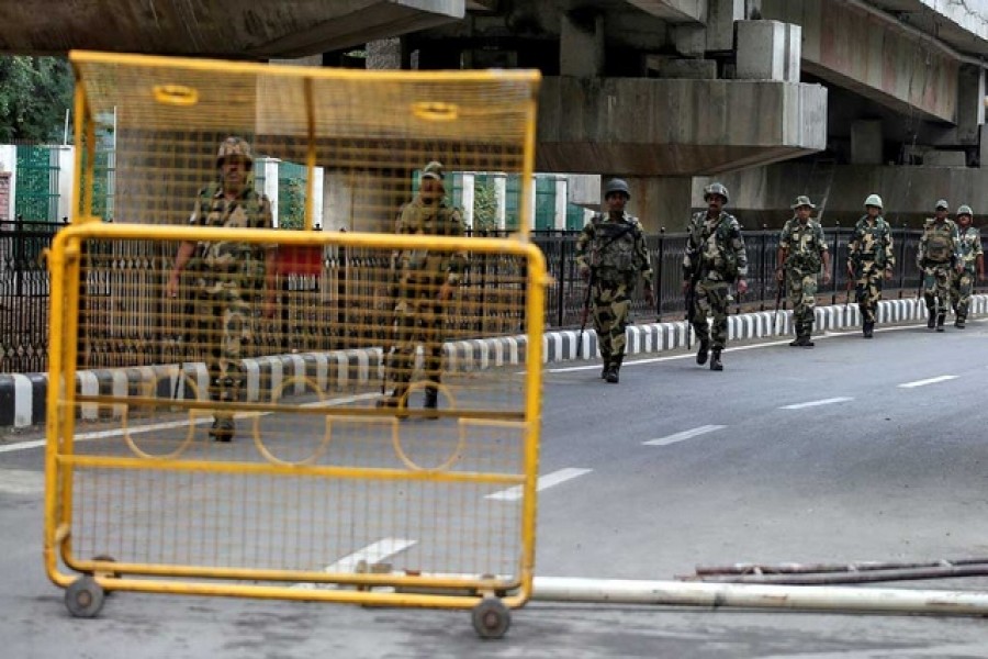 Indian security forces personnel patrol a deserted road during restrictions after the government scrapped special status for Kashmir, in Srinagar Aug 7, 2019. Reuters