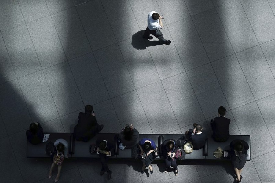 In this May 10, 2019, photo, a man walks in shade of a building as other people rest at a bench in Tokyo - AP Photo/Eugene Hoshiko