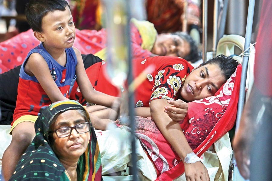 An under-treatment dengue patient as well as her anxious relatives giving a forlorn look at the Mugda Medical College and Hospital in Dhaka city on Friday — FE Photo by KAZ Sumon