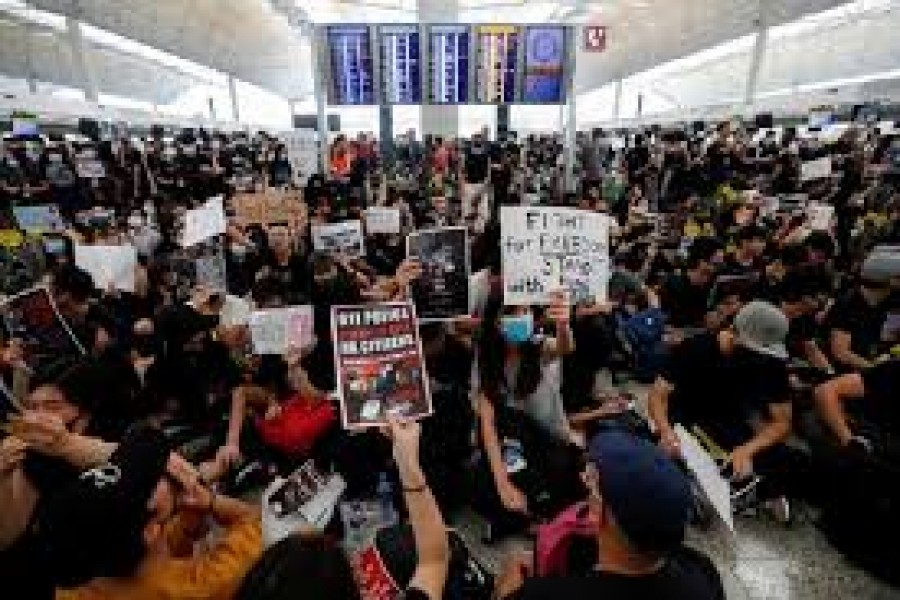 Protesters throng Hong Kong airport again after it reopens