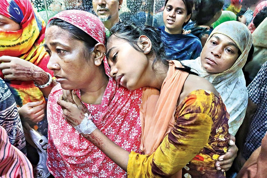 A mother taking her daughter, Sumaiya, who is suffering from dengue fever for the last five days, to her hospital bed after she gave blood sample for test at Mugda Medical College Hospital in the city on Friday — FE photo by Shafiqul Alam