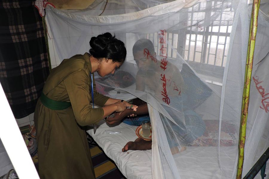 A nurse pushing an injection to a dengue-affected patient at Magura 250-bed hospital on Sunday	— FE Photo