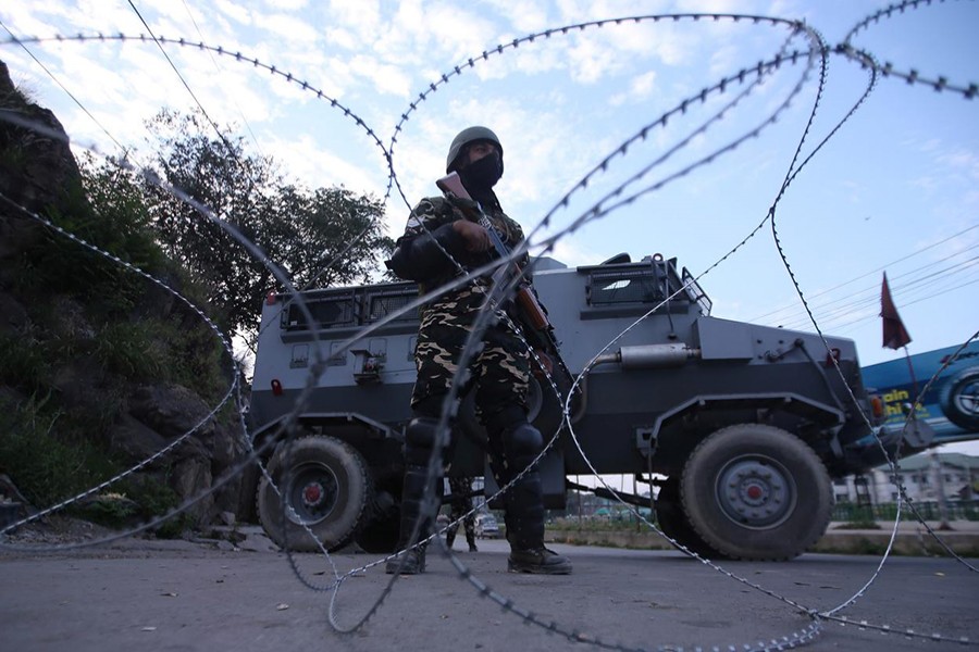 An Indian security personnel stands guard on a deserted road during restrictions after scrapping of the special constitutional status for Kashmir by the Indian government, in Srinagar on August 23, 2019 — Reuters photo