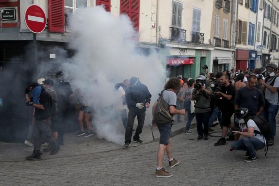 Demonstrators react after police used tear gas during a protest against G7 summit, in Bayonne. Reuters