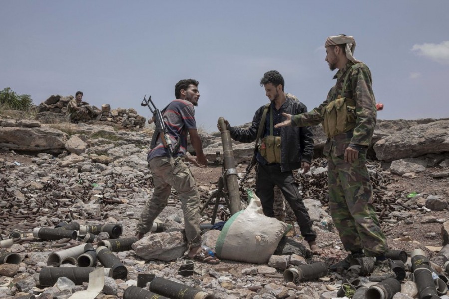 In this Monday, Aug. 5, 2019, file photo, fighters from a militia known as the Security Belt, that is funded and armed by the United Arab Emirates, discuss launching a mortar towards Houthi rebels, in an area called Moreys, on the frontline in Yemen's Dhale province - AP Photo/Nariman El-Mofty, File