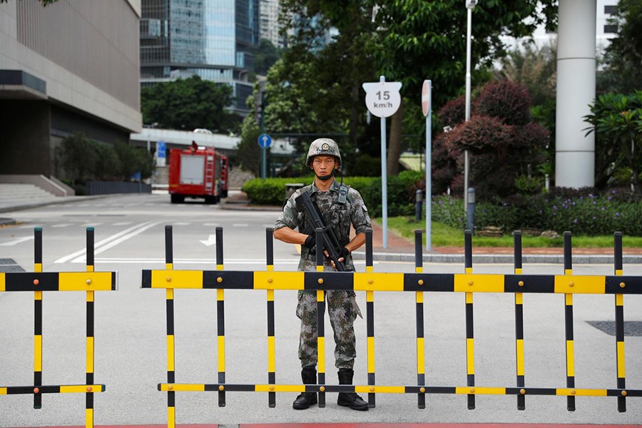 A Chinese People's Liberation Army (PLA) soldier guards the entrance to the PLA Hong Kong Garrison headquarters in the Central Business District in Hong Kong, China on August 29, 2019 — Reuters photo