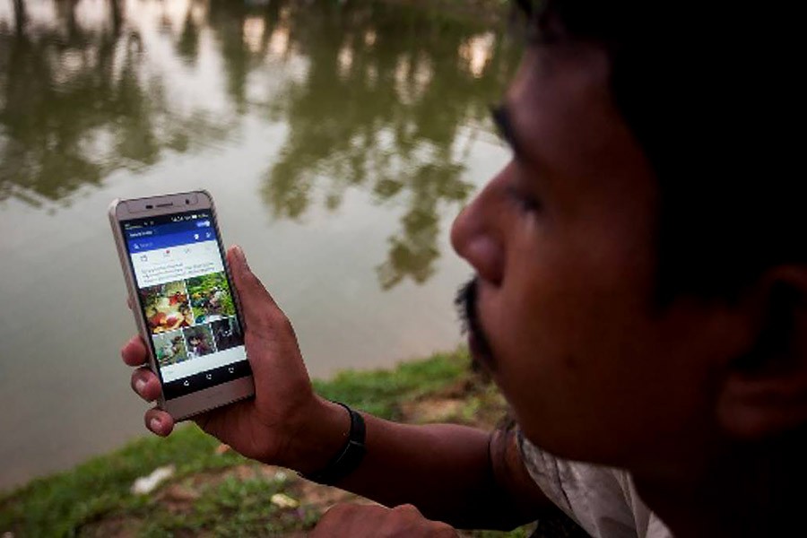 This file photo shows a Rohingya youth operating mobile phone using Bangladeshi network. Photo: UNB